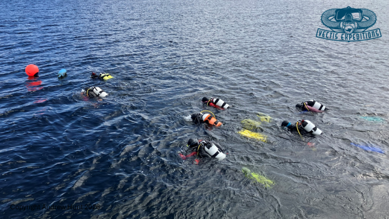 Divers swimming to shotline